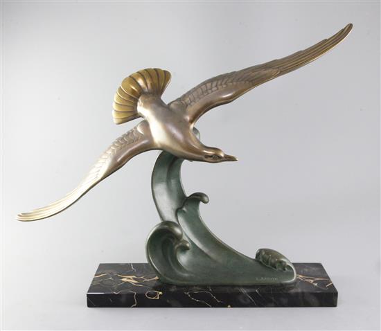 L. Carvin. An Art Deco patinated bronze model of a seagull swooping over a wave, width 20.5in.